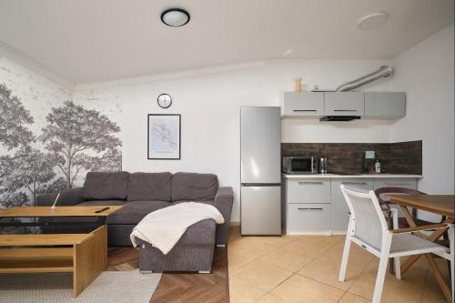 a living room with a couch and a table at Apartamenty Złotoryja Silver 2 in Złotoryja
