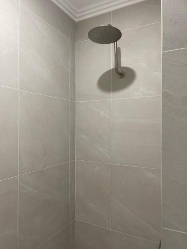 a tiled shower with a lamp in a bathroom at Coastal Calm Seascapes Halls Head in Falcon