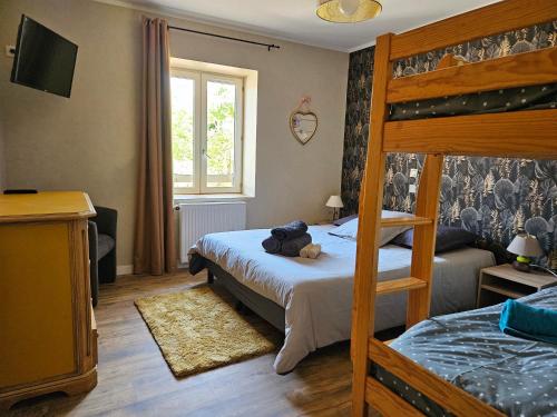 a bedroom with a bunk bed with a teddy bear on it at Gites de groupes Les Muriers in Bourgvilain