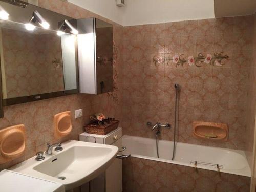 a bathroom with a sink and a shower and a tub at Alassio Mare e non Solo in Alassio