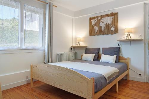a bedroom with a bed with two pillows on it at Chambres d'Emilie - Table d'Hôte in Lau-Balagnas