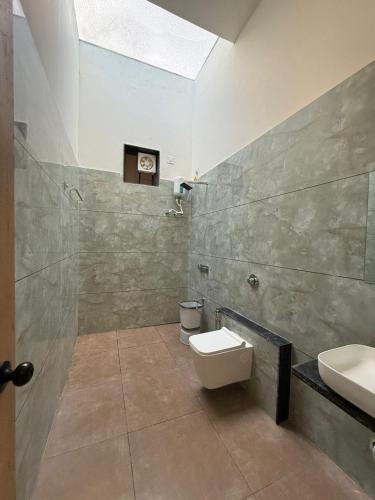 a bathroom with a toilet and a sink at Sylvara Resort in Sasan Gir