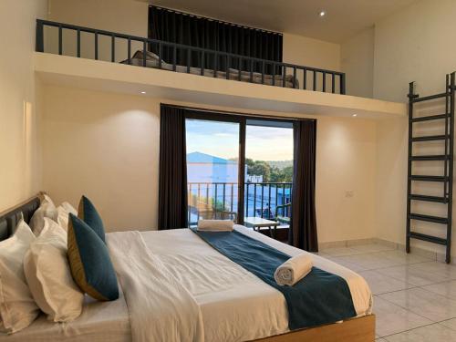 a bedroom with a bunk bed and a balcony at Sylvara Resort in Sasan Gir
