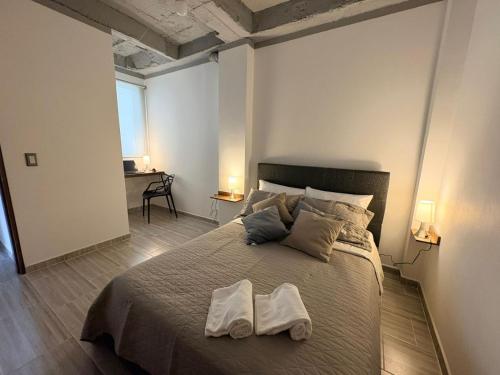 a bedroom with a large bed with two towels on it at Villa Celeste Guaduas El Mirador in Guaduas