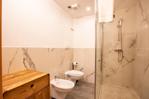 a bathroom with a toilet and a shower at Chalet Bellavista in Spiazzi Di Caprino