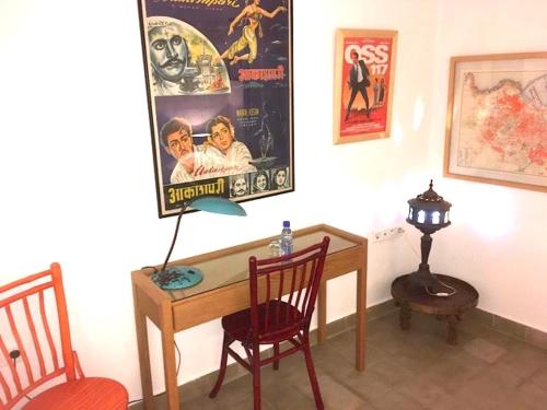 a room with a desk with two chairs and a lamp at Dar Nour in Tangier