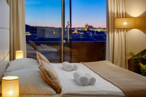 a hotel room with a bed with towels on it at Wenceslas Hotel & Apartments in Prague