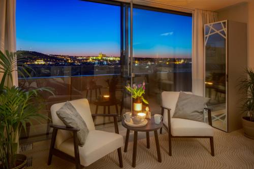 a living room with a view of a city at Wenceslas Hotel & Apartments in Prague