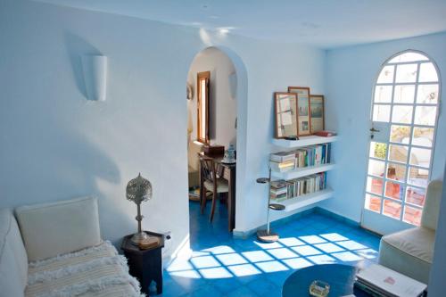 a blue living room with a couch and a table at Dar Nour in Tangier