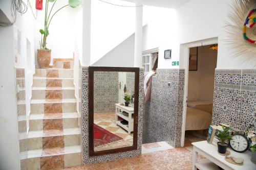 a mirror in the middle of a room with a staircase at Nizar Surf Morocco in Taghazout