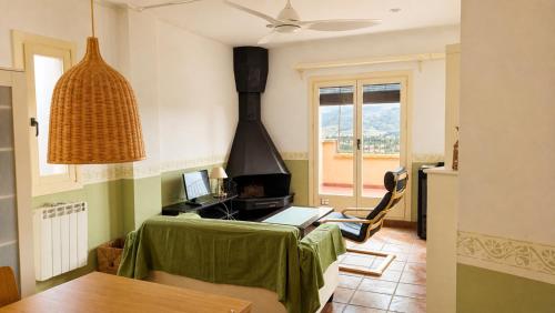 a kitchen with a stove and a table with a laptop at Ca la Genoveva in Montsonis