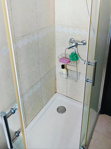 a shower with a glass shower door with a shower at TurisMar Vila do Conde in Macieiro da Maia