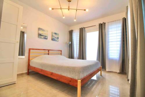 a bedroom with a bed and a large window at 1.7 • Balcony • Generator • Parking • 2nd Floor in Mayaguez