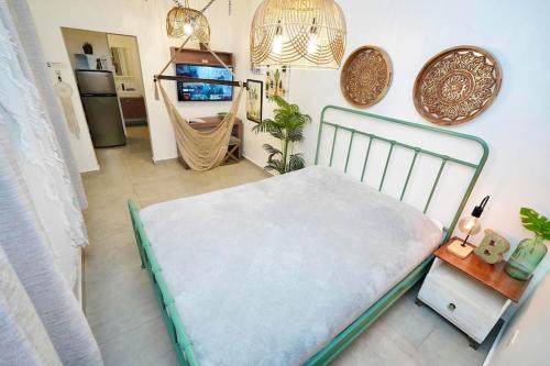 a bedroom with a bed and a tv in a room at 1.4 • Generator • 1st Floor • Parking • 238sf in Mayaguez