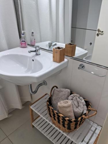 a bathroom with a sink and a toilet and a mirror at Metra DS Puerto Norte in Rosario