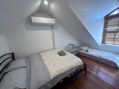 a bedroom with two beds in a attic at 2 Bedroom Pyrmont Terrace House in Sydney