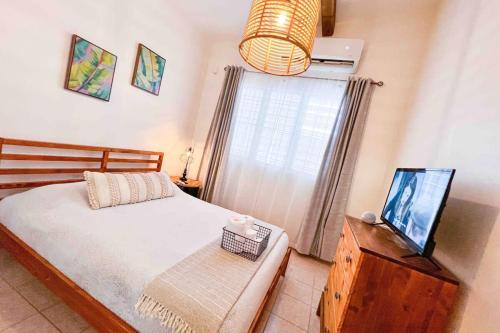 a bedroom with a bed and a television on a dresser at 3.7 Near Beach • Generator • Hammock • 2nd floor in Garita