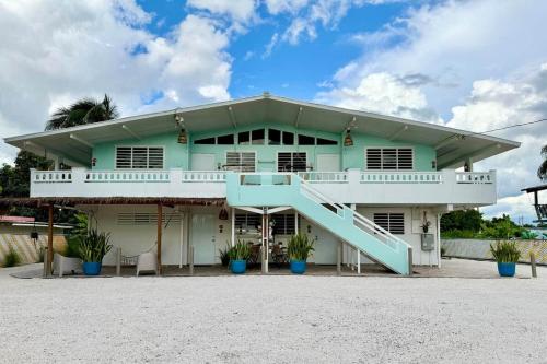 a house with a blue staircase in front of it at 3.7 Near Beach • Generator • Hammock • 2nd floor in Garita