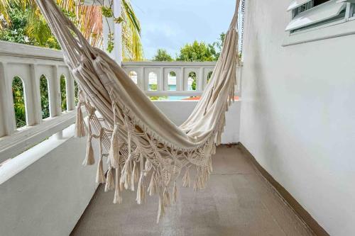 a hammock hanging on a balcony with a window at 3.8 Near Beach • Generator • Hammock • 2nd floor in Garita