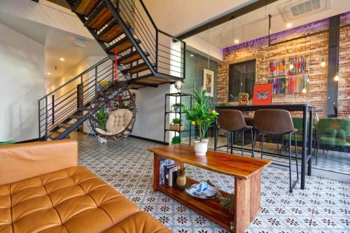 a living room with a couch and a table at 5.5 Loft • Lobby • Generator • Parking • 2nd Floor in Mayaguez