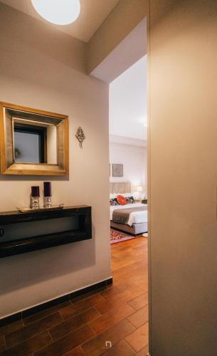 a bedroom with a bed and a mirror on the wall at MARON in Kalavrita