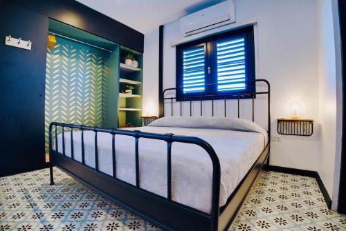 a bedroom with a large bed with a window and a door at 5.7 Penthouse • Generator • Parking • 3rd floor in Mayaguez