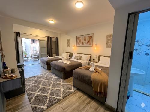 a hotel room with two beds and a balcony at Park Plaza Haven in Cairo