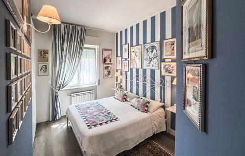 a bedroom with blue and white striped walls and a bed at 2 Bedroom Awesome Apartment In Chiavari in Chiavari