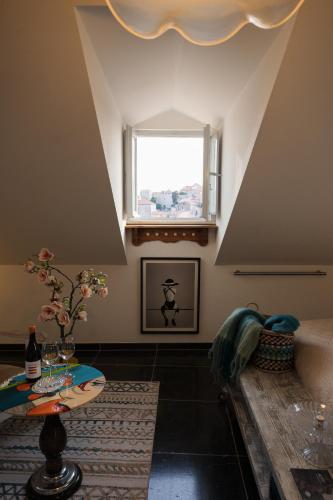 a living room with a table and a window at Prijeko Palace in Dubrovnik