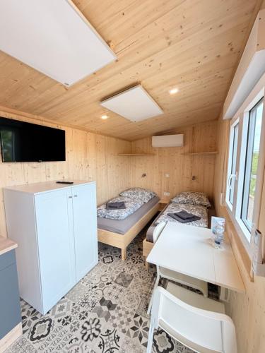 a room with a bed and a desk and a table at Tiny Stay Guesthouse - Würzburg in Würzburg