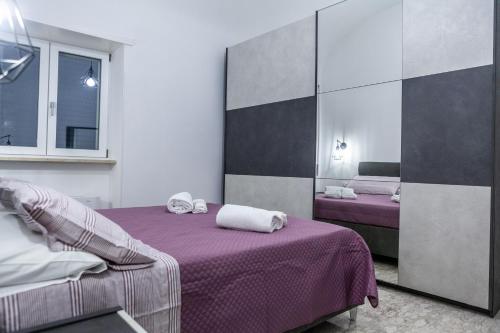 a bedroom with two beds with purple sheets at Cerenea House BiancAntò in Isola del Liri