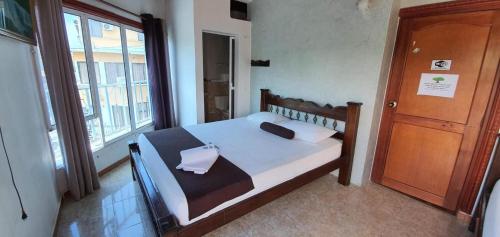 a bedroom with a bed and a window at Hotel Las Golondrinas in Puerto Berrío