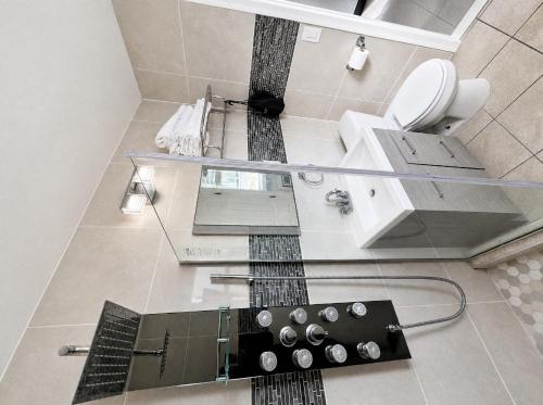 a bathroom with a glass sink and a toilet at Sunrise Inn in Wildwood