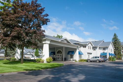 a large white house with a car parked in the driveway at Grand Beach Resort Hotel in Traverse City