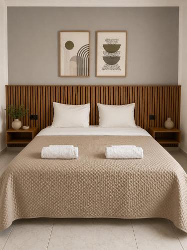 a bedroom with a large bed with two pillows at Harmonia Himara in Himare