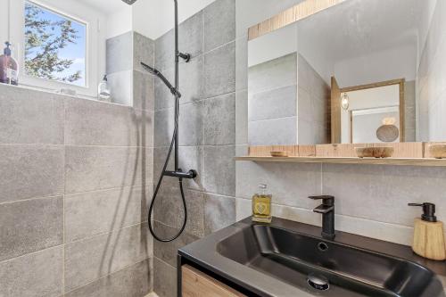 a bathroom with a sink and a shower at Les Gîtes Du Saro in Chabestan