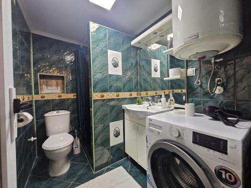 a bathroom with a washer and a toilet and a sink at Casa Di Kotor in Kotor