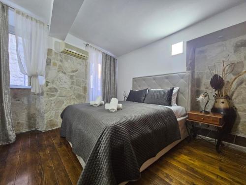 a bedroom with a bed with two stuffed animals on it at Casa Di Kotor in Kotor