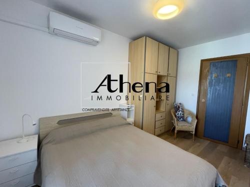 a bedroom with a bed and a cabinet and a chair at Sole in Grado