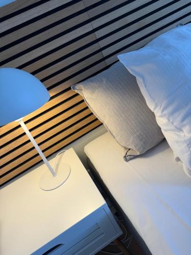 a bed with a pillow and a lamp on it at Humble Kro og Hotel in Humble