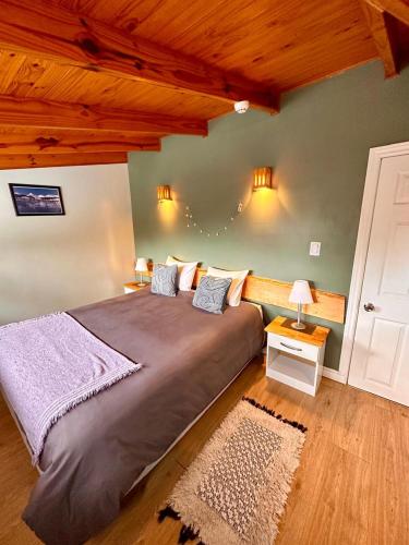 a bedroom with a large bed in a room at Buenavida Guesthouse in Ushuaia