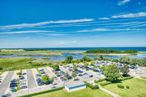 an aerial view of a parking lot next to the water at Ferienpark - Haus H, App 0H1107 - Apartment Baltic Panorama in Heiligenhafen