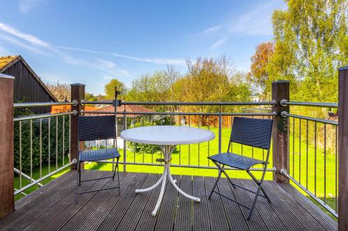 a table and two chairs on a deck at Ferienwohnung Schlossperle in Klütz