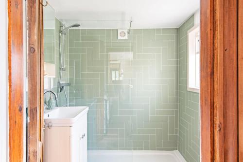 a bathroom with a shower and a sink at Pebble Beach Cottage by Keepers Cottages in Kingsdown