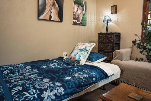 a bedroom with a bed and a couch and a chair at Home on a Hill Accommodation in Tzaneen