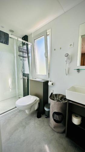 a bathroom with a toilet and a sink at Mobile Home Camp Dalmata Orebić in Orebić