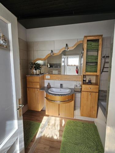 a bathroom with a sink and a mirror at Ferienhaus Birker in Kleinfeistritz