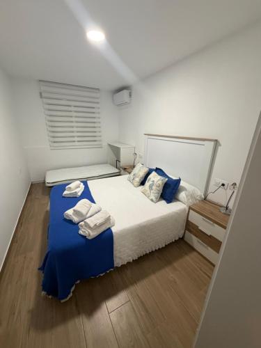 a bedroom with a bed with two towels on it at Costa Relax in Puerto de Mazarrón