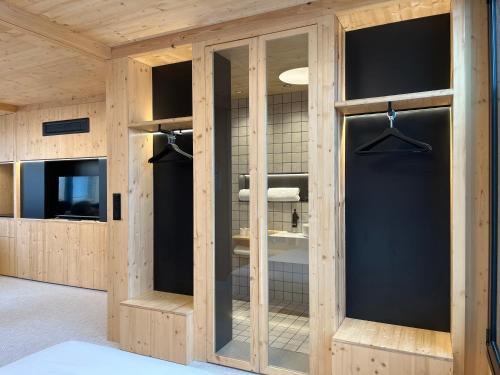 a room with wooden walls and glass doors at VTZ Minimal Suites in Zaragoza