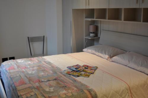 a bedroom with a bed with a quilt on it at Casa Katia in Lezzeno